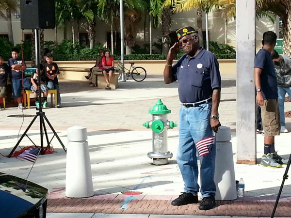 City Commisisoner Ike Robinson saluting the troops as they move by.